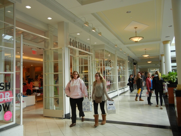 Shoppers stroll by the Forever 21 in the King of Prussia Mall ...