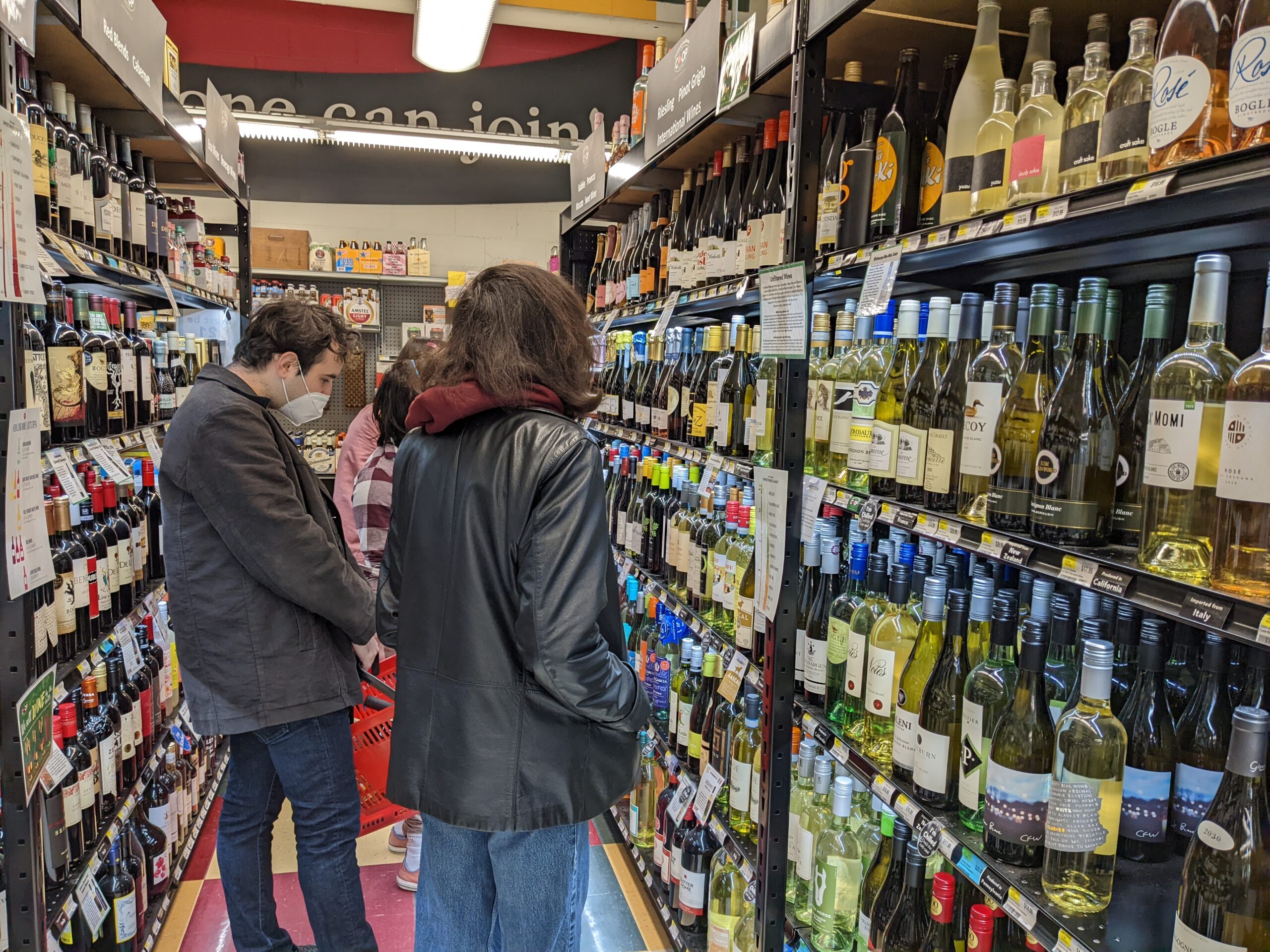 Students looking at wine in the Swarthmore CO-OP's wine aisle